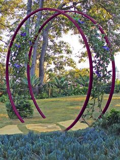 an artistic sculpture in the middle of a garden