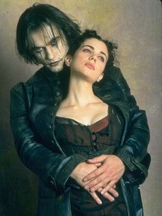 a man and woman are dressed up as dracula and the girl is holding her head