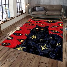 a living room area rug with a black cat on it's red and blue design