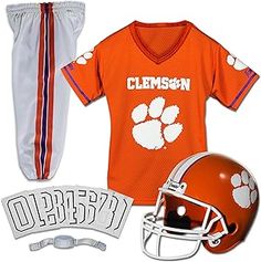 an orange football uniform and helmet with the clemson logo on it, along with other items