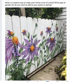 a painted fence with purple flowers on it