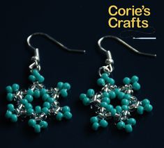 the earrings are made with turquoise beads and silver wire, which is shaped like a snowflake