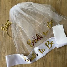 the bride's sash has been decorated with gold lettering