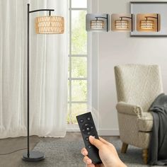 a person holding a remote control in front of a living room with a chair and lamp