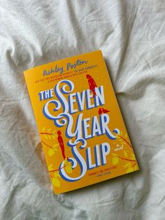 the seven year slip book is laying on a bed