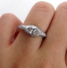 a woman's hand with a diamond ring on it