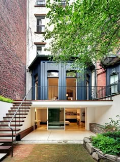 an apartment building with stairs leading up to the second floor