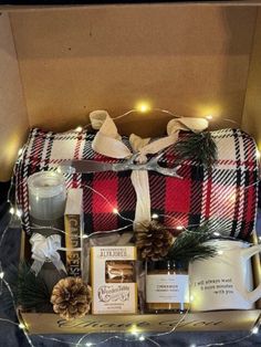 a christmas gift box filled with coffee, candles and other holiday items for someone's special occasion