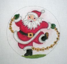 a cross stitch santa clause on a white background with gold trimmings and beads