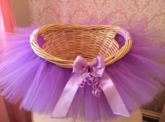 a wicker basket with purple tulle and bow