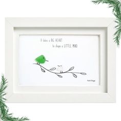 a green bird sitting on top of a tree branch in front of a white frame