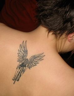 a woman with a tattoo on her back