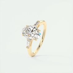 a yellow gold engagement ring with a pear shaped diamond