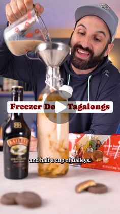 a man is pouring something into a blender with ingredients around him on the table