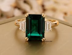 "★ RING INFORMATION ★ ------------------------------------------------------------------- ★ MAIN STONE ➺ SHAPE  :- Emerald Green cut  (lab created) ➺ Weight :- 4.90 ct (11 x 9 mm) (app.) ➺Gem color :  Green ➺Luster: Excellent ➺ Make: High Quality ➺Clarity : VVS ------------------------------------------------------------------- ★ SIDE DIAMOND  ➺ SHAPE  :-Trapezoid Cut Moissanite  ➺ Weight :- 0.50ct  ➺Gem color :  White/ Colorless ➺Luster: Excellent ➺ Make: High Quality ➺Clarity : VVS ------------------------------------------------------------------- ★ BAND  ➺ BAND WIDTH :- 1.8 mm  ➺ BAND THICKNESS :- 1.5 mm  ➺ Metal Tone: Yellow Gold , White Gold , Rose Gold (10KT,14KT,18KT) ➺ Finish : High Polished All stone are fixed with prong setting 3.5ct Emerald Diamond Engagement Ring 14k Solid gol Wedding Ring Minimalist, Emerald Diamond Engagement Ring, Emerald Ring Engagement Diamond, Minimalist Engagement Ring, Lab Created Emerald, Dream Engagement Rings, Emerald Engagement, Diamond Wedding Ring, Ring Minimalist