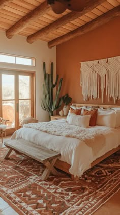 a large bed sitting inside of a bedroom next to a window