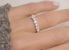 a woman's hand with a diamond ring on it