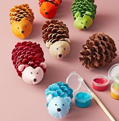 there are pine cones and hedgehogs made out of felt on the pink background