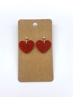 These stunning heart earrings are cut from red glittered acrylic and attached to a gold ball stud.  These are perfect for Valentine's Day or girls night out!  Grab a pair for you or as a gift for her!  If you love these, check out the shop for more options!  Happy shopping! White Acrylic Earrings, Red Gemstone Jewelry, Valentines Day Earrings, Red Heart Earrings, Romantic Earrings, Winter Earrings, Valentines Earrings, Ghost Earrings, Pumpkin Earrings