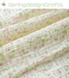 the fabric is white with pink and green flowers on it, as well as text that says spring designs crafts