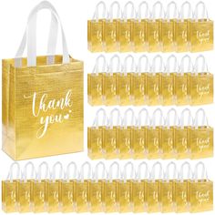 gold gift bags with white handles and thank you written on the front, along with small clear handbags