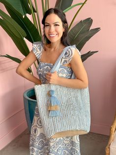 Feeling blue never looked so good! America & Beyond - Natural Beauty Upcycled Hand-Woven Light Blue Tote is here to add a splash of eco-friendly fun to your life. This multi-purpose tote, crafted from hand-weaving fabric with a lurex, is perfect for any adventure. With double shoulder straps adorned with lace details and a playful pom pom tassel charm, it's super stylish & so easy to carry. Inside, you'll find a hanging zip pocket for your essentials and a magnetic button closure to keep everyth Blue Cotton Beach Bag For Vacation, Blue Handwoven Summer Beach Bag, Blue Cotton Beach Bag For Summer, Blue Cotton Summer Beach Bag, Handwoven Blue Summer Bag, Blue Handwoven Summer Bags, Summer Blue Handwoven Bags, Blue Handwoven Bags For Spring, Eco-friendly Blue Beach Bag For Summer