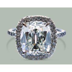 an oval cut diamond with double halos on the shoulders and sides, surrounded by pave diamonds