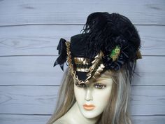 Beautiful ladies black tricorn with golden tan satin pleated trim with black and gold braid. Black cocarde with a hand painted floral accent, black ostrich feathers and black satin bows. Please measure your head before purchasing as I do not take returns and all sales are final. The inside circumference is 22.5" with a built-in adjustable string. Just cinch and tie for a better fit. Perfect for Renaissance Fairs, Gasparilla Pirate event, 1800's Victorina events or even Halloween. Check out my other hats and fascinators in my shop. Please let me know if you have any questions.   All sales are FINAL, no returns or exchanges please keep this in mind before purchasing. Victorian Brimmed Costume Hats And Headpieces, Victorian Brimmed Costume Hat, Victorian High Crown Costume Hat, Adjustable Black Costume Hats And Headpieces For Ceremonial, Adjustable Black Costume Hat For Ceremonial Occasions, Black Pirate Mini Hats For Costume, Vintage Black Costume Hats And Headpieces For Carnival, Vintage Black Costume Hat For Carnival, Victorian Hat For Costume Party