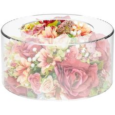 a clear glass container with flowers on the inside and bottom, sitting on a white surface