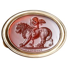 This exquisite intaglio is masterfully engraved onto carnelian and features Eros (Cupid) riding a lion. The motif in art is often accompanied by the Latin phrase, "Omnia vincit amor” or "Love conquers all”. The composition is engraved onto carnelian and set in an 18K gold signet ring. Production time for this piece is 12-14 weeks. Can be made in any size ranging from 6-12 Chavdar Chushev is an artist, restorer, jeweler, and master of the ancient art of gem carving. His extensive knowledge of gem Gem Carving, Ancient Jewels, Gold Finger Rings, Ancient Jewellery, Contemporary Engagement Rings, Love Conquers All, Gold Lion, Art Ancien, Silver Signet Ring