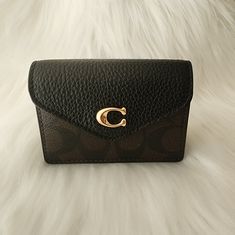 Coach Black Signature Tammie Card Case Holder (Nwt) Carry Your Id, Cash, And Credit Cards In Style With This Beautiful And Lavish Card Case. It Features Goldtone Hardware, Black Leather Trim, And Coach's Signature Print. I Dont Know If My Photos Did The Soft, Luxurious, Wine Color Interior Justice. Details: - Signature Coated Canvas & Refined Pebble Leather - Snap Closure (Sturdy) - Front Has One Card Slot - Exterior Has A Slip Pocket - Imported Size: 4'' (L) X 3'' (H) X 1.25'' (W) Color: Gold/Brown Black All Closet Item Prices Are Negotiable, So Don't Hesitate To Make An Offer. These Lovelies Need Good Homes And Someone To Enjoy Them. Thanks For Browsing! Coach Card Holder, Elegant Coach Leather Card Holder, Black Rectangular Coach Card Holder, Black Coach Card Holder, Chic Black Coach Wallet, Coach Black Wallets With Card Slots, Brown Leather Wallet, Billfold Wallet, Card Case Wallet