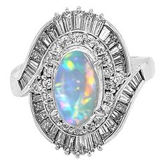 A superb ring hand fabricated in platinum. It features a 2.60 carat crystal opal with brilliant play of color. Bright flashes of red, green and orange dance across the dome of this precious opal. It is accented by 1.74 carats of VS quality diamonds, baguette and round cuts, crossing each other and ending on the sides of the ring. Ring Size 8.25 Precious Opal, Spiral Ring, Ring Hand, Crystal Opal, Women Diamond, Opal Crystal, Ring Ring, Quality Diamonds, Cocktail Rings