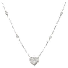 18k White Gold 0.87ctw Diamond Heart and Diamond Station Necklace Product: Diamond Heart Station Necklace Material: 18k White Gold Diamond Details: There are approximately 0.87 carats of Princess cut, modified Princess cut, and Round Brilliant cut diamonds. The Princess cut diamonds are arranged in the shape of a heart. There are Round Brilliant diamonds around the heart in a halo, and there are 6 diamond stations along the chain Diamond Clarity: Diamonds are approximately VS/SI (Very Slightly I Chain Diamond, Station Necklace, Princess Cut Diamonds, Drop Necklace, Diamond Color, Round Brilliant Cut Diamond, Diamond Heart, Diamond Clarity, Princess Cut