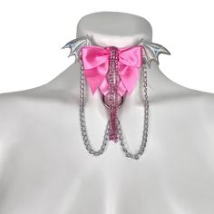 Choose the color elastic, bow, wing, and hardware you want to recreate this look to fit your style! Adjustable neck band. Petal Pink elastic, halo wings, medium pink bow, crystal rhinestones, silver chains, and silver hardware pictured here. Satin Elastic • Adjustable Straps • Hand Wash • Air Dry Pink Party Jewelry With Butterfly Knot Detail, Pink Party Jewelry With Butterfly Knot, Pink Ribbon Jewelry For Party, Pink Bow Jewelry For Party, Pink Party Jewelry With Bow Detail, Pink Punk Jewelry For Party, Adjustable Pink Jewelry For Cosplay, Thigh Garter, Leg Garters