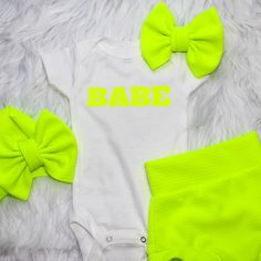 Break out the sunglasses.  This Neon Yellow Personalized Baby Bummie set is so Shiny and Bright.  It's perfect for a a day out, Birthday Party, baby shower gift, Coming home outfit, Baby announcement Photos, or just visiting family.   You can personalize your Bodysuit with your Little Ones Name, in place of "BABE".   In the personalization box type the name as desired.  It will be in all caps Choose from the bummies, bodysuit, bow, headband or get the whole set. Its so much fun to mix and match Fitted Basic Summer Onesie, Basic Fitted Summer Onesie, Summer Basic Fitted Onesie, Summer Onesie With Letter Print For Gender Reveal, White Summer Bodysuit For Gender Reveal, White Bodysuit For Summer Gender Reveal, White Casual Diaper Cover For Playwear, Casual White Diaper Cover For Playwear, Customizable Fitted Onesie For Summer