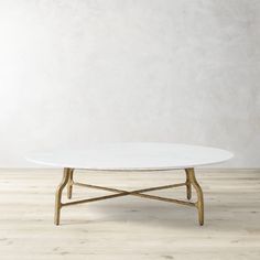 a white marble coffee table with gold legs