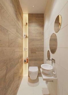 a bathroom with two sinks and mirrors on the wall