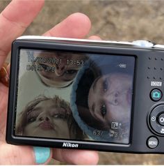 a person holding up a camera with two pictures on the screen in front of them