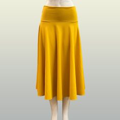 Elevate Your Wardrobe With Our Women's Ribbed Skirt, A Versatile Essential That Effortlessly Blends Comfort With Contemporary Style. Crafted From A Soft And Stretchy Ribbed Fabric, This Skirt Offers A Flattering Silhouette That Hugs Your Curves In All The Right Places. The Ribbed Texture Adds Depth And Dimension, Creating A Sophisticated Look That Transitions Seamlessly From Day To Night. Available In A Range Of Timeless Colors, Our Ribbed Skirt Is Designed To Be Both Flattering And Functional. Fitted Yellow Bottoms Solid Color, Fitted Yellow Solid Color Bottoms, Fitted Yellow Bottoms, Yellow Solid Color Skirt For Summer, Yellow Stretch Flared Skirt, Yellow Solid Color Skirt For Spring, Spring Yellow Solid Color Skirt, Spring Stretch Yellow Maxi Skirt, Yellow Stretch Maxi Skirt For Spring