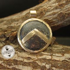 "This Spartan Shield necklace is hand sculpted, domed and beaten up to look like it has been on a battlefield. The letter lambda (Λ), standing for Laconia (administrative capital of Sparta) or Lacedaemon (ancient name for the city of Sparta), which was painted on the Spartans' shields, was first adopted in the 420s BC, and quickly became a widely known Spartan symbol. Military families passed on their shields to each generation as family heirlooms. - Hand sculpted pendant - Solid yellow bronze a Hammered Medallion Amulet Jewelry, Hammered Round Amulet Jewelry, Bronze Round Amulet Necklace, Handmade Coin-shaped Amulet Jewelry, Bronze Hammered Sterling Silver Jewelry, Bronze Round Pendant Jewelry, Bronze Hammered Round Pendant Jewelry, Hammered Coin Jewelry Gift, Hammered Coin Jewelry For Gift