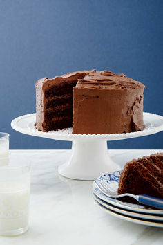 A chocolate cake on a white porcelain platter with a slice removed and sitting on a blue and white plate. Blueberry Rolls, Joshua Weissman, Mocha Frosting, Unsweetened Chocolate, Round Cake Pans, Round Cakes, Frosting Recipes, Unsweetened Cocoa, Decadent Desserts