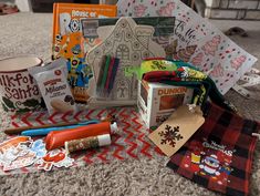 the contents of a christmas crafting kit are laid out on the floor next to other items