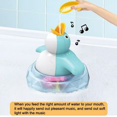 a child's bathtub with musical notes coming out of it and a toy penguin in the tub