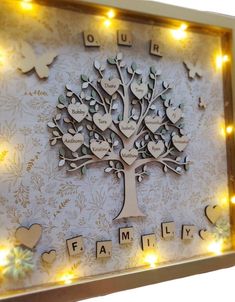 a lighted family tree with hearts and butterflies on the sides, surrounded by words that spell out their names