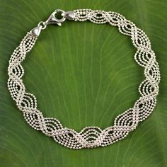 Working in sterling silver Angels of Thailand crafts a bracelet that evokes a myriad flowing rivers. Diminutive ball chains come together to create the shining illusion.