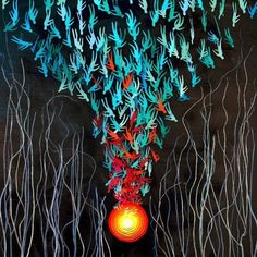 an abstract painting with blue, red and green leaves hanging from it's sides