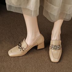 Looking for a unique and stylish way to add a little extra height to your look? Check out our amazing selection of loafer heels! These amazing shoes feature a square toe and a nude finish. with a gold chain detail that adds a touch of luxury. Whether you're dressing up for a special occasion or just want to add a little extra glamour to your everyday look. these shoes are sure to make you stand out from the crowd. Upper: Sheepskin Lining: Microfiber Outsole: TPR Toe: Square Toe Closure: Slip on Elegant Chain Heels For Spring, Trendy Beige Office Heels, Trendy Beige Heels For Work, Elegant Gold Heels With Gold Chain, Trendy High Heel Loafers For Party, Chic Gold Loafers With Metal Feet, Trendy Beige Formal Loafers, Elegant Gold Loafers, Elegant Formal Heels With Gold Chain