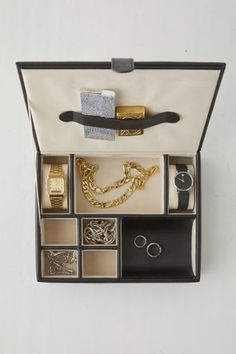 Add a luxe finish to your getting-ready space with this jewelry storage box from Mele and Co Crafted from vegan leather with sand suede lining, this storage box features seven compartments in a variety of sizes to hold all of your essentials. Complete with two padded watch cushions and a coin slide. Finished with a slim storage strap under the lid to hold your cash, lighters and more. Features Luxe vegan leather watch box from Mele and Co Lined with sand suede 4 Small compartments 2 Watch compar Modern Rectangular Jewelry Storage Box Included, Modern Rectangular Jewelry Storage With Box, Luxury Formal Jewelry Storage Box, Luxury Jewelry Storage Gift Box, Luxury Rectangular Jewelry Storage Gift Box, Elegant Rectangular Jewelry Storage Gift Box, Elegant Formal Jewelry Storage Box, Slim Storage, Leather Watch Box