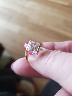 This ring is in 14kt yellow gold and has a 1.5 carat diamonique synthetic diamond. The size is 5 and is sizeable. This ring is bezel set on two sides and open on the other two, this allows the light to come in and makes the ring sparkle. The princess cut stone is set on an angle, and is so beautiful. This ring looks and feels like a million bucks Please don't purchase this on advertising sites and instead visit my store sedonasthings at Etsy thank you 14k Gold Jewelry With Princess Cut And Bezel Setting, 14k Gold Jewelry With Bezel Setting In Princess Cut, Elegant Princess Cut Rings With Bezel Setting, Formal Solitaire Princess Cut Jewelry, Elegant Princess Cut Ring With Bezel Setting, Formal Solitaire Jewelry With Princess Cut, Formal Fine Jewelry Topaz Princess Cut Ring, Princess Cut Diamond Ring With Tension Setting, Princess Cut Rings With Bezel Setting For Anniversary