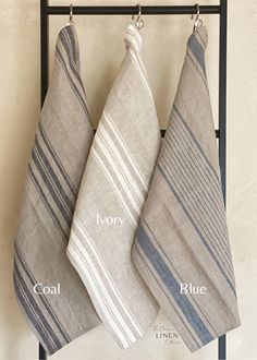 three towels hanging on a towel rack with the words coal and blue written below them